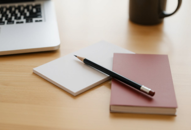 pencil and a small notebook on a desk
